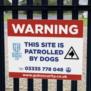 warning dogs patrolling sign