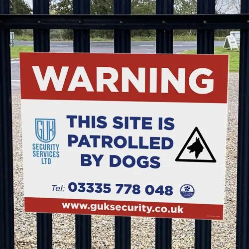 warning dogs patrolling sign