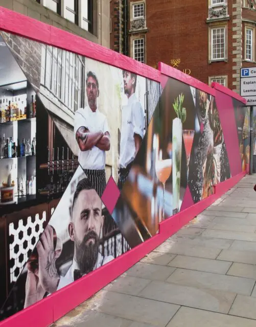 Hoarding sign outdoor business sign advertising boards installed around a hotel development in York city Centre