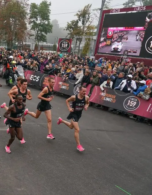 racers with crowd and event signage