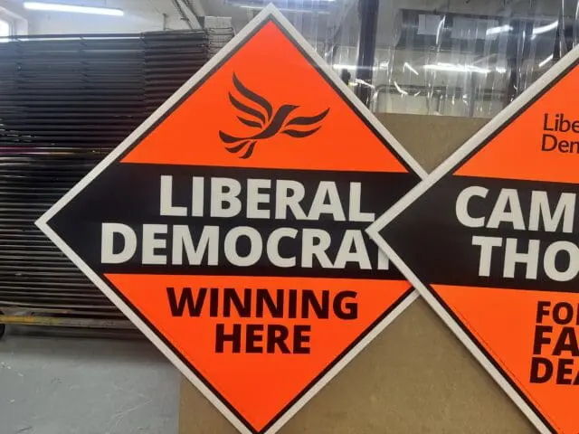 Lib Dem election sign printed in day glo orange and black on white Correx