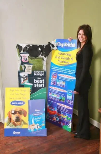 lifesize strutted show cards for display and advertising, shown next to a woman for scale
