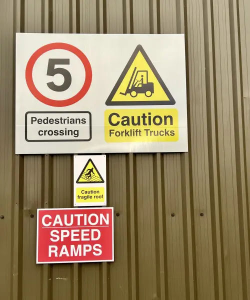 Health and safety signage displayed on a warehouse for speed restrictions