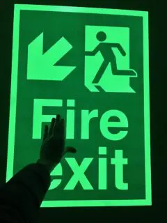 Photoluminescent fire exit sign
