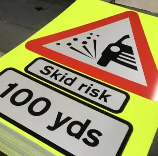 Reflective skid risk road signs