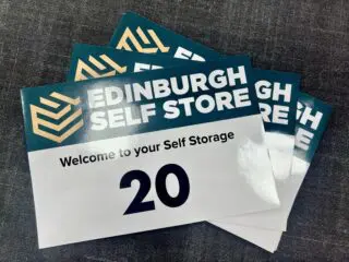 Branded storage container decals featuring Stirling Self Store logo and company colours