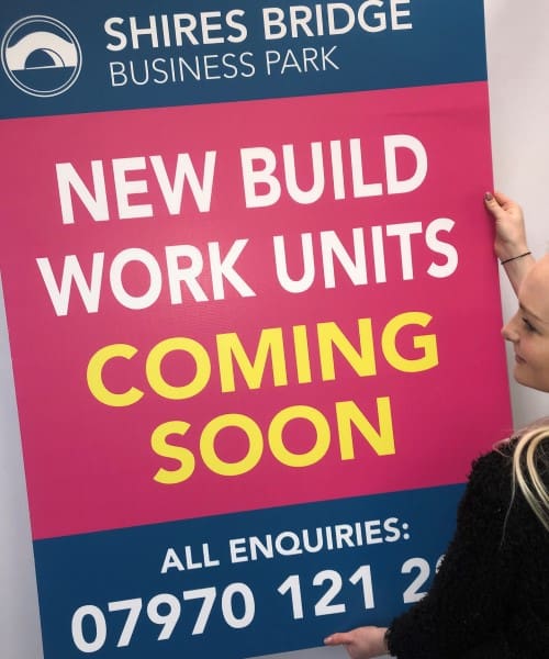 pink day glo correx sign advertising new build properties coming soon ready for displaying