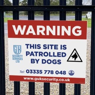 warning dogs patrolling sign