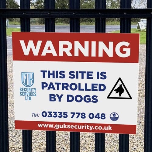 warning dogs patrolling sign