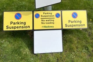 Wrap around parking suspension signs