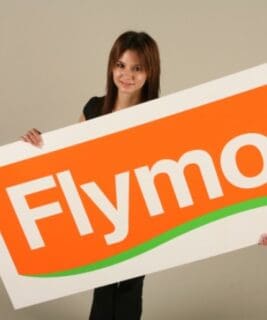 woman holding a Flymo logo sign board