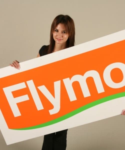 woman holding a Flymo logo sign board