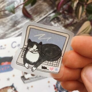 custom sticker with cat sitting on a laptop printed on a transparent vinyl 