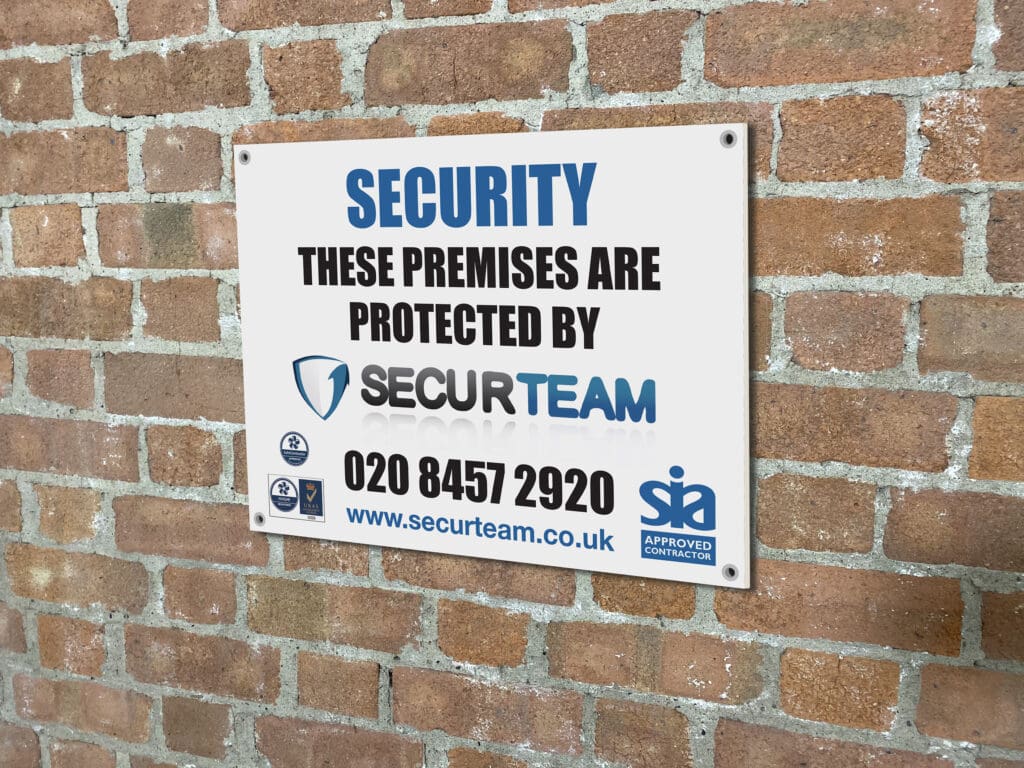 custom printed security sign board displayed on brick