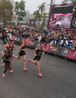 racers with crowd and event signage