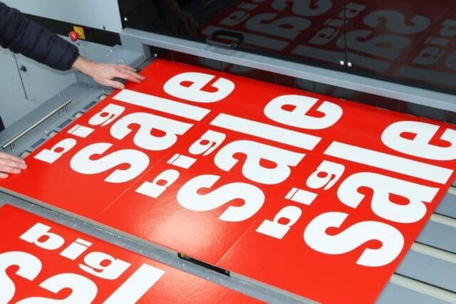 Red and white big sale signage custom printed for retailers in the UK
