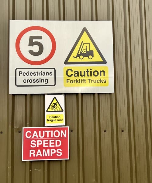 Health and safety signage displayed on a warehouse for speed restrictions